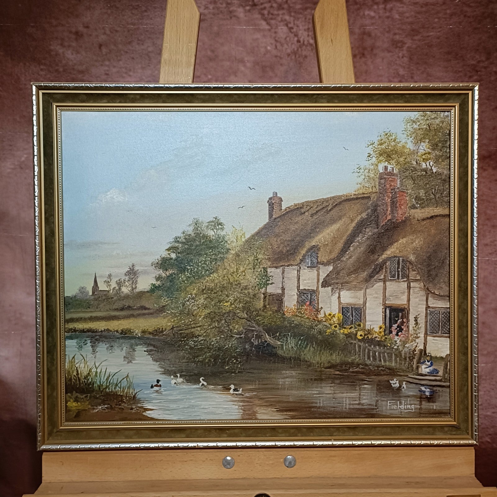 Framed original oil on canvas painting of Thatch Cottage on River Nadder by Curated Treasures, showcasing a charming rural scene.